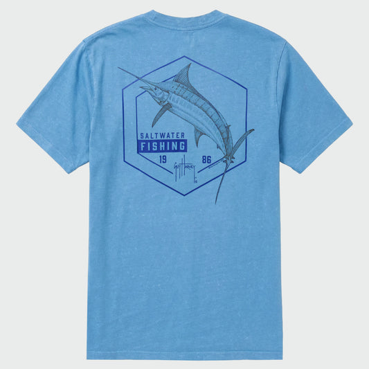 Flat lay of a blue washed t-shirt with a marlin graphic on the back against a light gray background