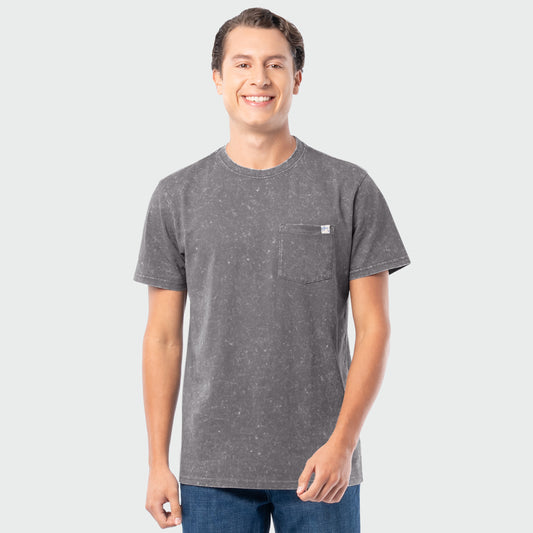 Man wearing a gray washed t-shirt with a small logo on a light gray background