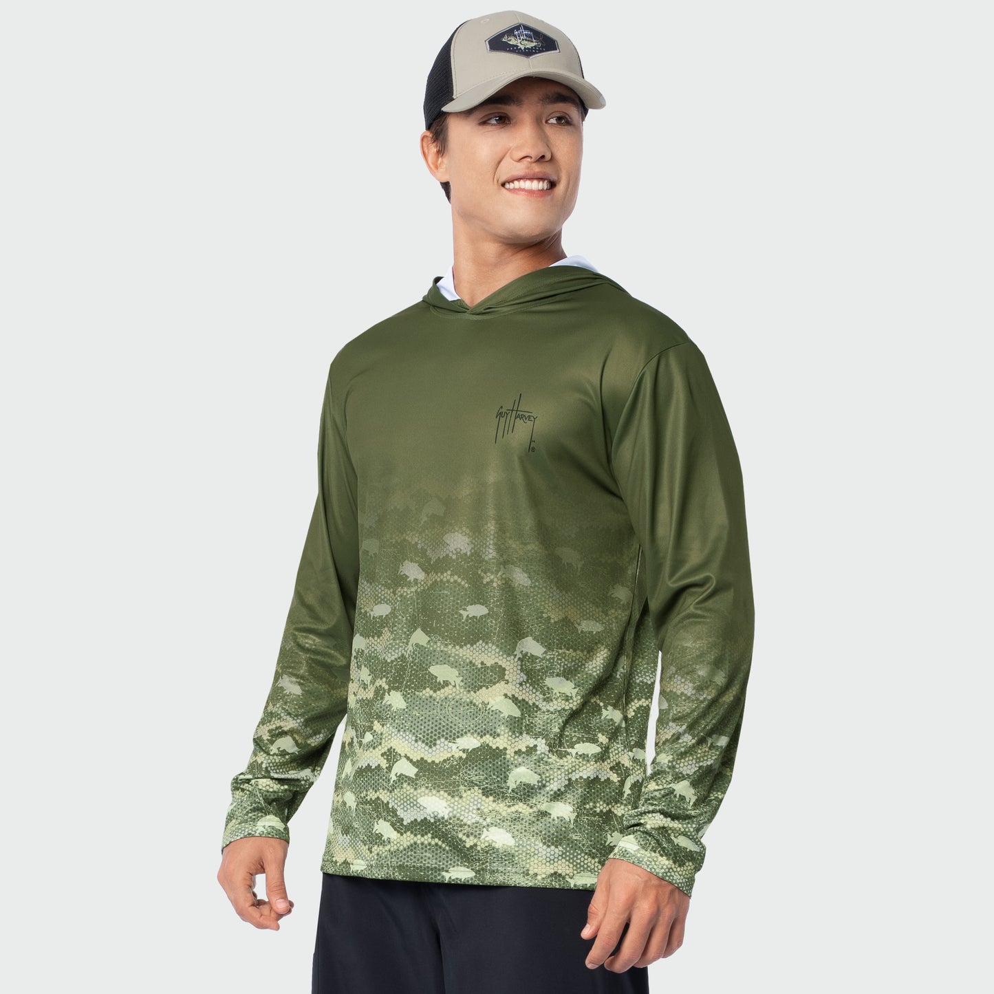 Man wearing a green camouflage hoodie and cap on a white background