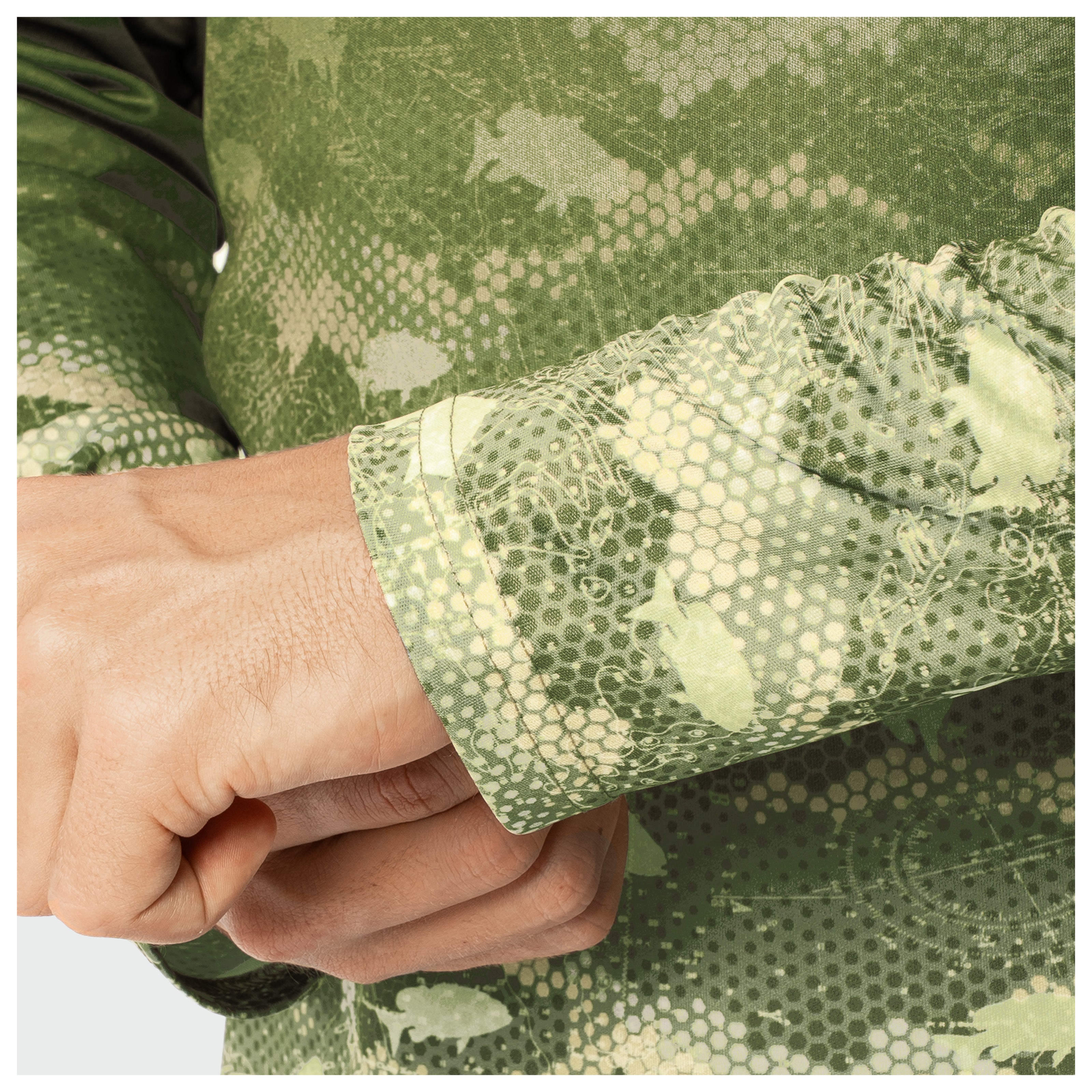 Close-up of a person wearing a green camouflage-patterned shirt with a textured sleeve.