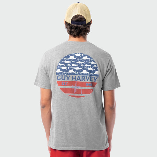 Person wearing a gray Guy Harvey t-shirt with an americana graphic design on the back.