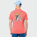 Man wearing a coral t-shirt with marlin and mahi fish design on the back, standing against a light gray background.
