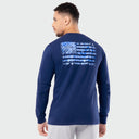 Man wearing a blue long-sleeve Guy Harvey shirt with an American flag graphic design on the back against a light gray background