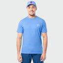 Man wearing a blue t-shirt and cap on a light gray background