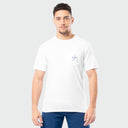 Man wearing a white t-shirt with a small Guy Harvey logo on a plain background