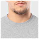 Close-up of a person wearing a gray sweater on a light gray background