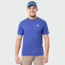 Man wearing a blue t-shirt with a Guy Harvey logo and a blue cap on a light gray background