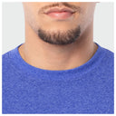 Close-up of a person wearing a blue shirt with a neutral background