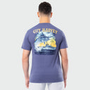 Person wearing a Guy Harvey t-shirt with a marlin and boat design on the back against a white background