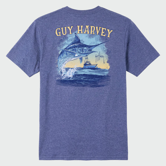 A flat lay image of a blue Guy Harvey threadcycle tee featuring a jumping marlin and a boat on the back.