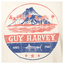 Circular Guy Harvey logo with a volcano, palm trees, and marlin illustration on a beige background