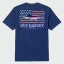 Flat lay image of a blue Guy Harvey t-shirt with a marlin americana graphic design on the back against a white background