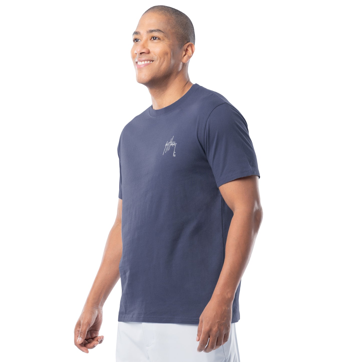Man wearing a navy blue t-shirt with a Guy Harvey logo on a white background
