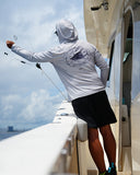 A man wearing an eco cast sun protection hoodie from Guy Harvey.