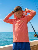 A smiling child pulling up their hood while fishing