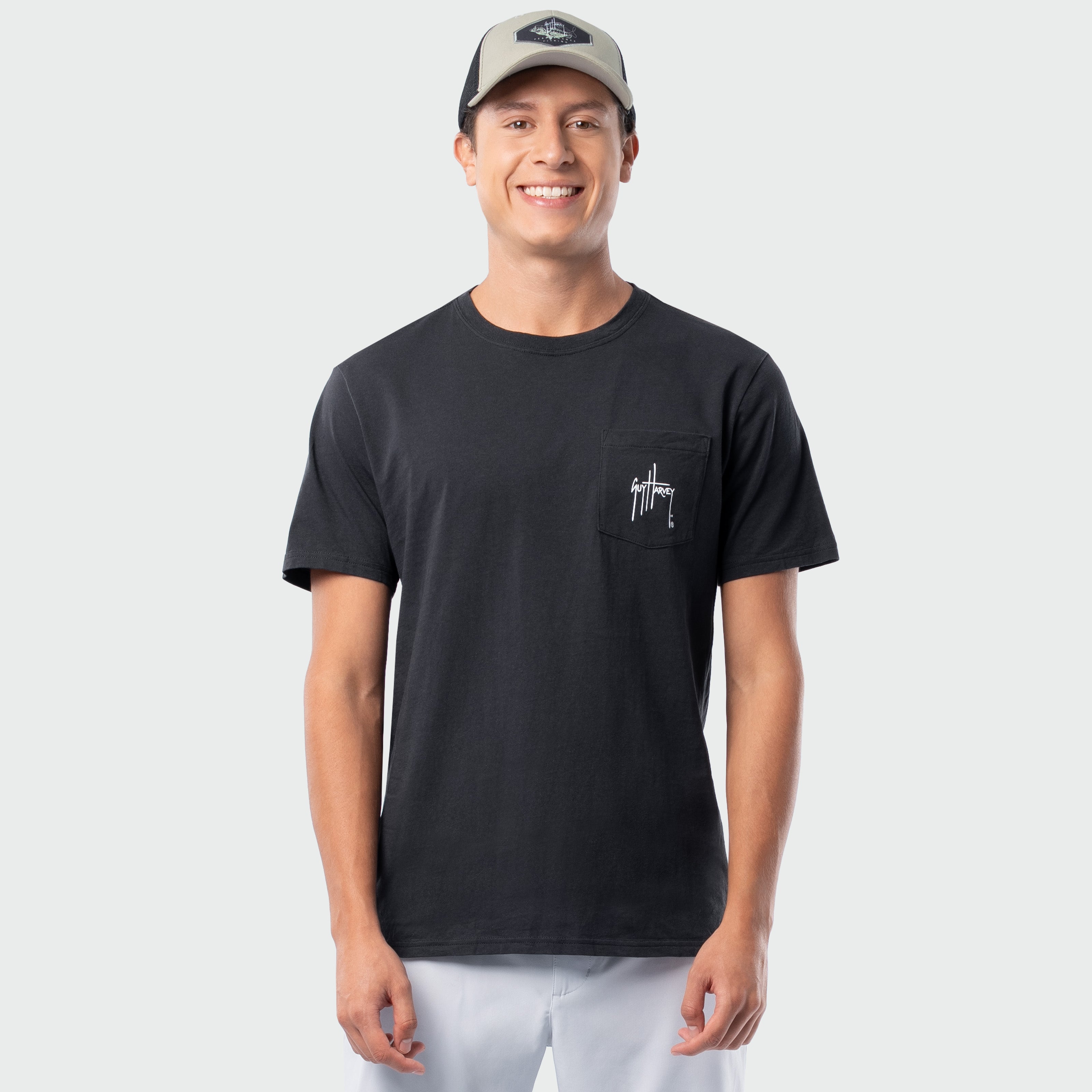 Man wearing a black t-shirt with a logo on a light gray background