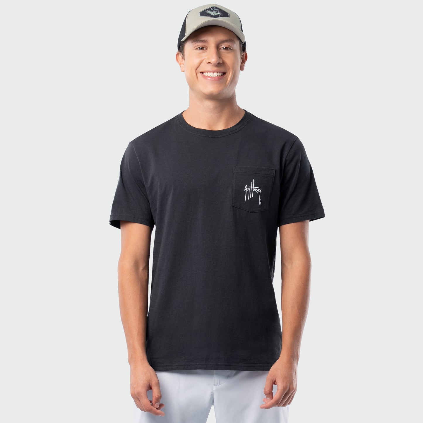 Man wearing a black t-shirt with a logo on a light gray background