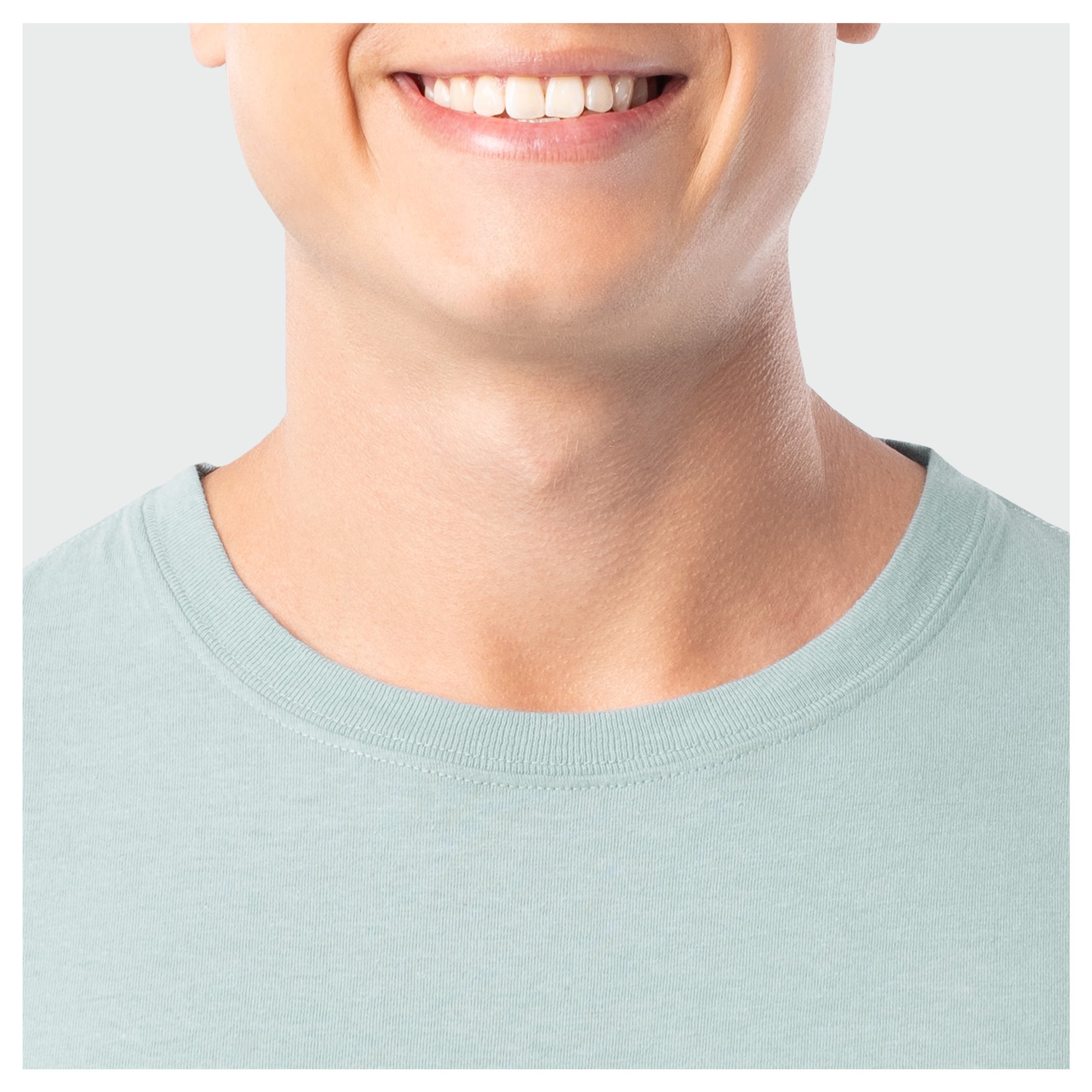 Close-up of a person wearing a light blue shirt with a plain background