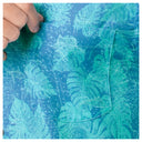 Close-up of a shirt with tropical leaf pattern and charts design.