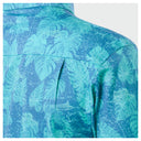 Close-up of a blue shirt with tropical leaf pattern on a white background