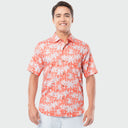 Man wearing a red and white palms patterned shirt on a light gray background