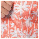 Close-up of the left chest pocket on a red floral shirt.