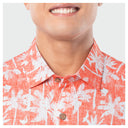 Close-up of a person wearing a red palm trees shirt with a white background