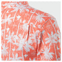Hawaiian type shirt with white palm tree pattern on a coral background