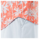 Close-up of a fabric with coral and white palm trees pattern on a white background
