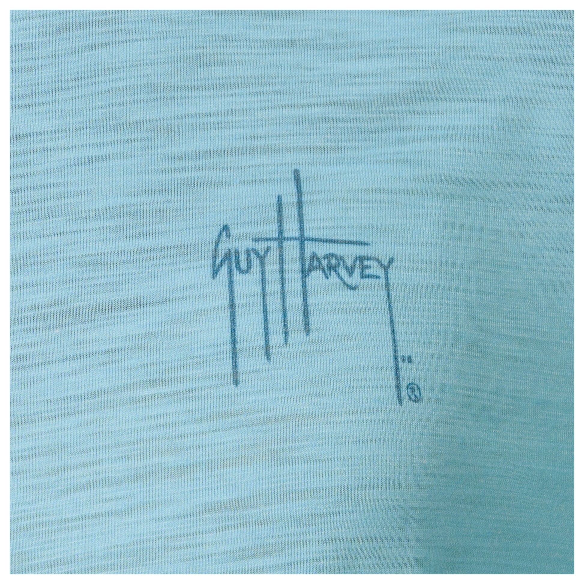 Close-up of a blue fabric with 'Guy Harvey' logo