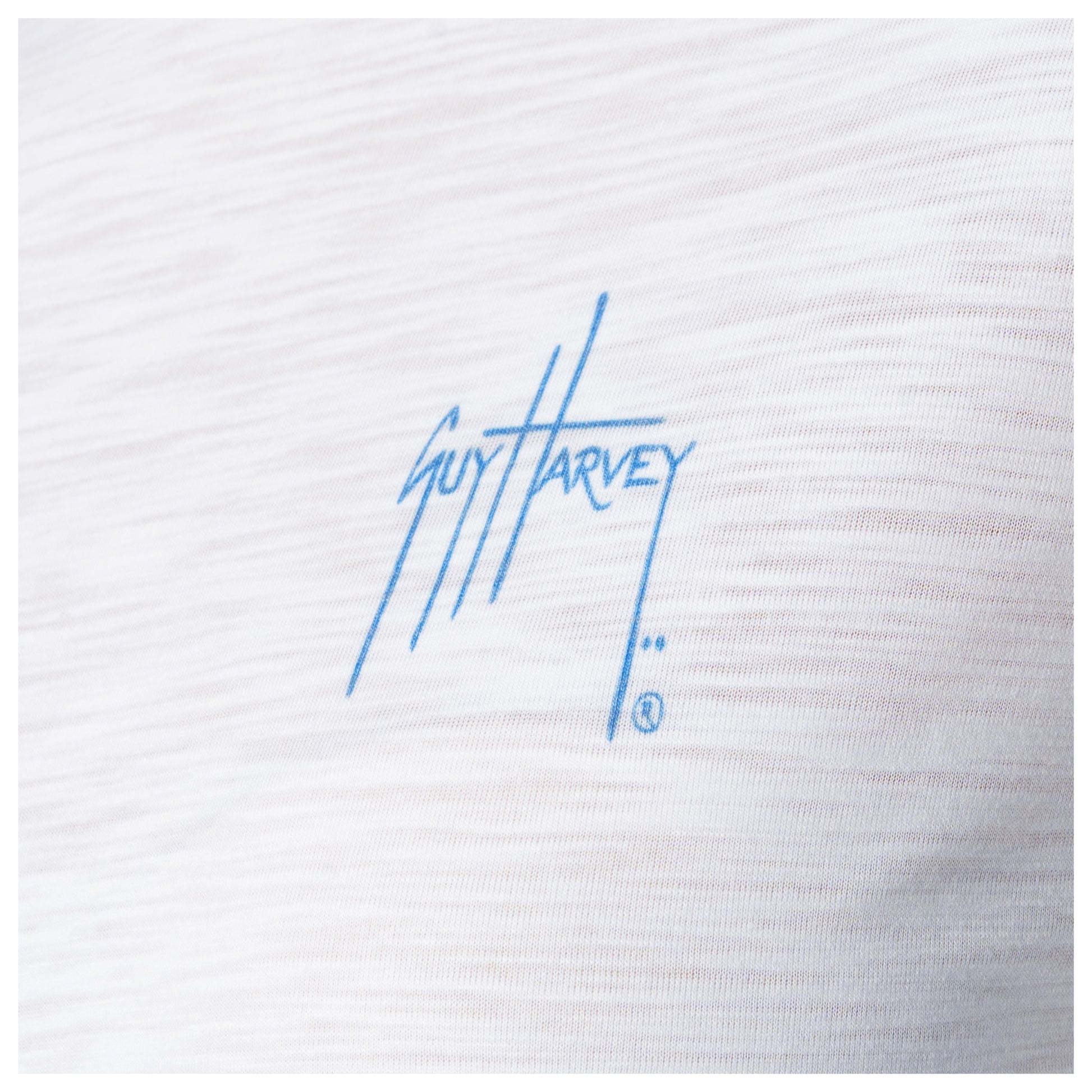 White fabric with blue 'Guy Harvey' logo