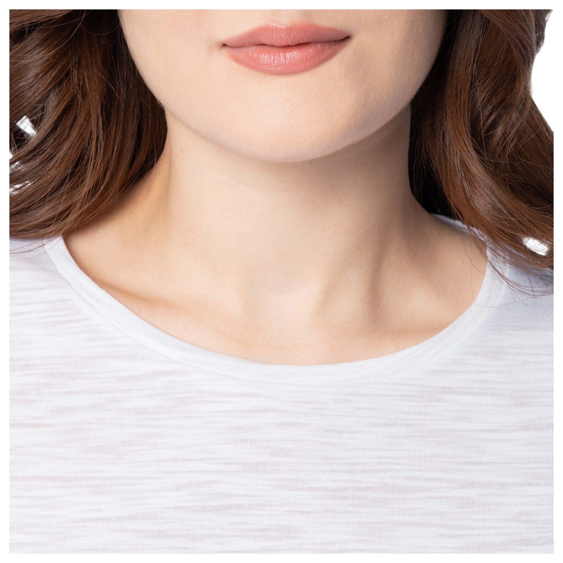 Close-up of a person wearing a white shirt with a blurred background