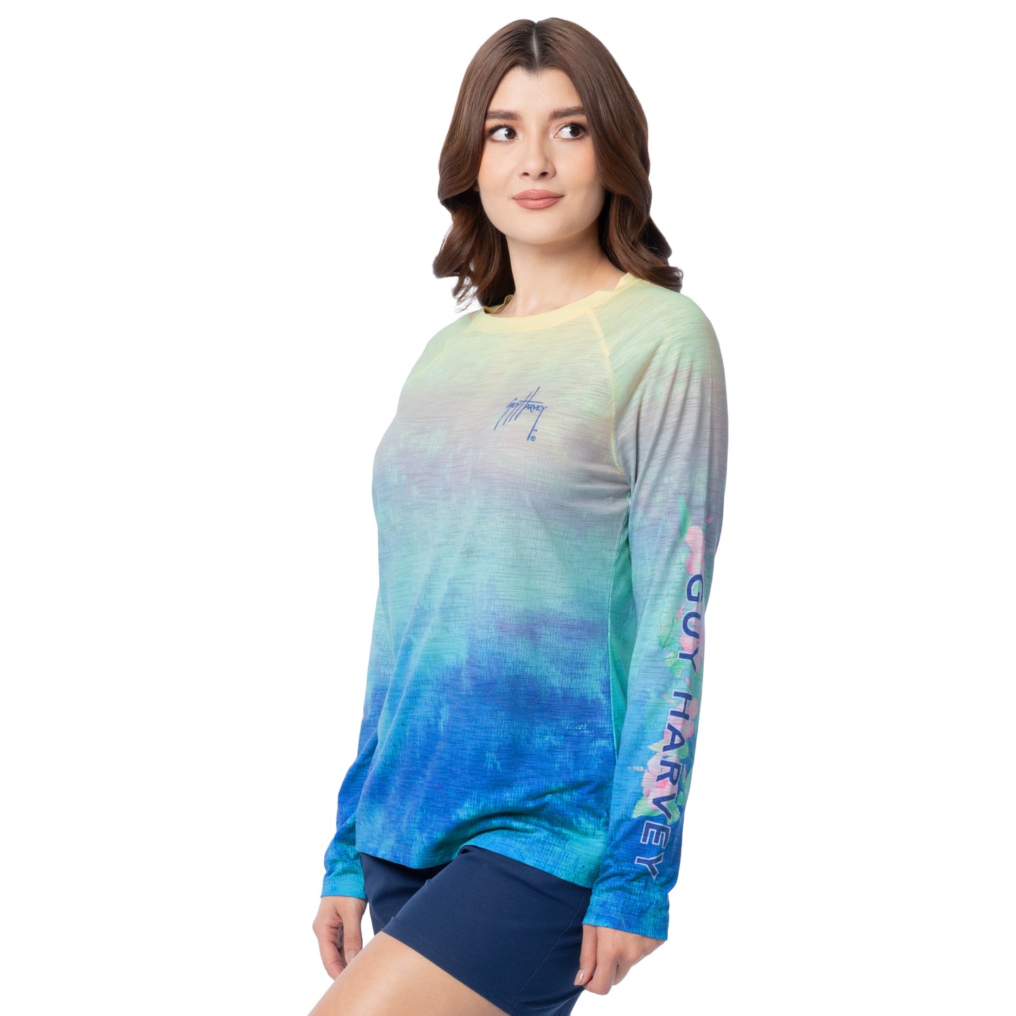 Woman wearing a colorful long-sleeve shirt with gradient design on a white background