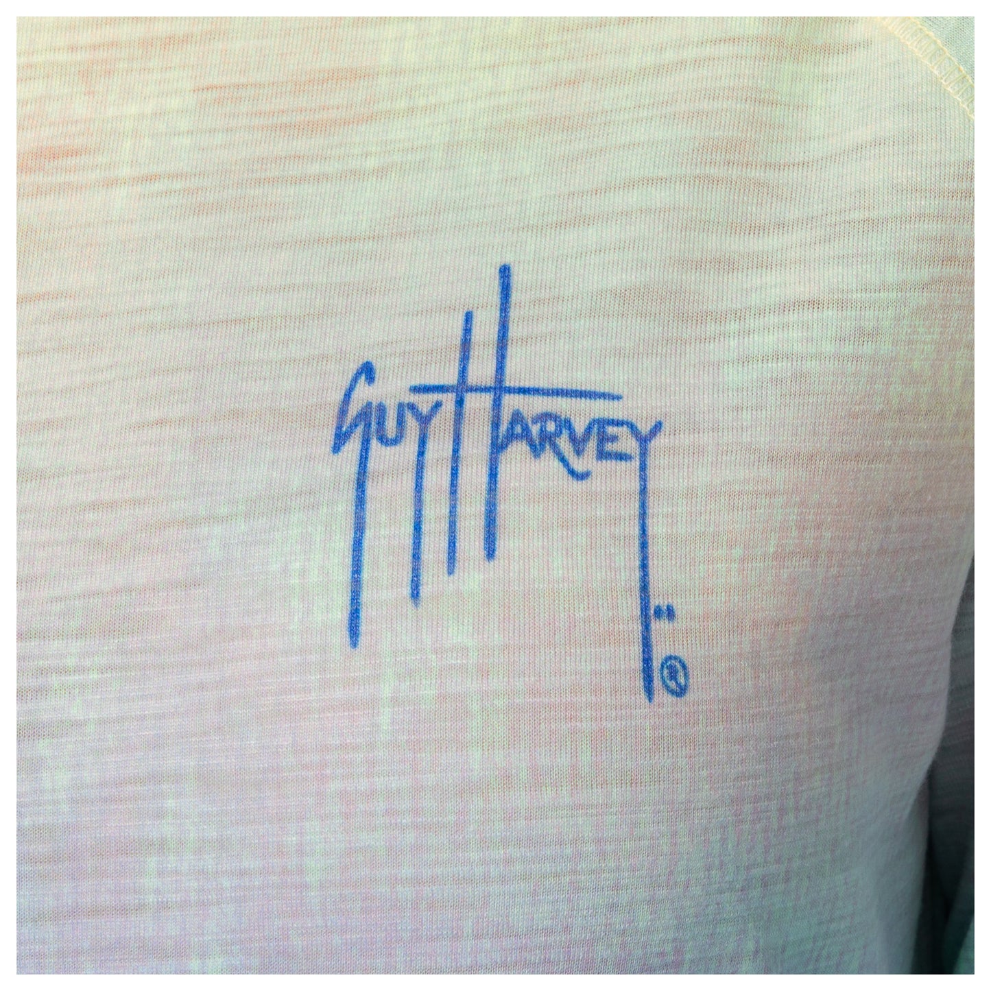 Blue logo of 'Guy Harvey' on a the left chest