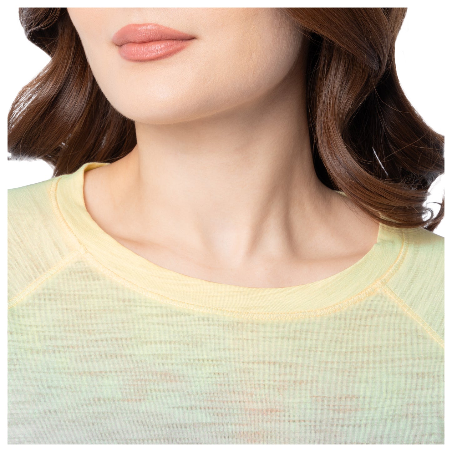 Close-up of a person wearing a light green top with a blurred background