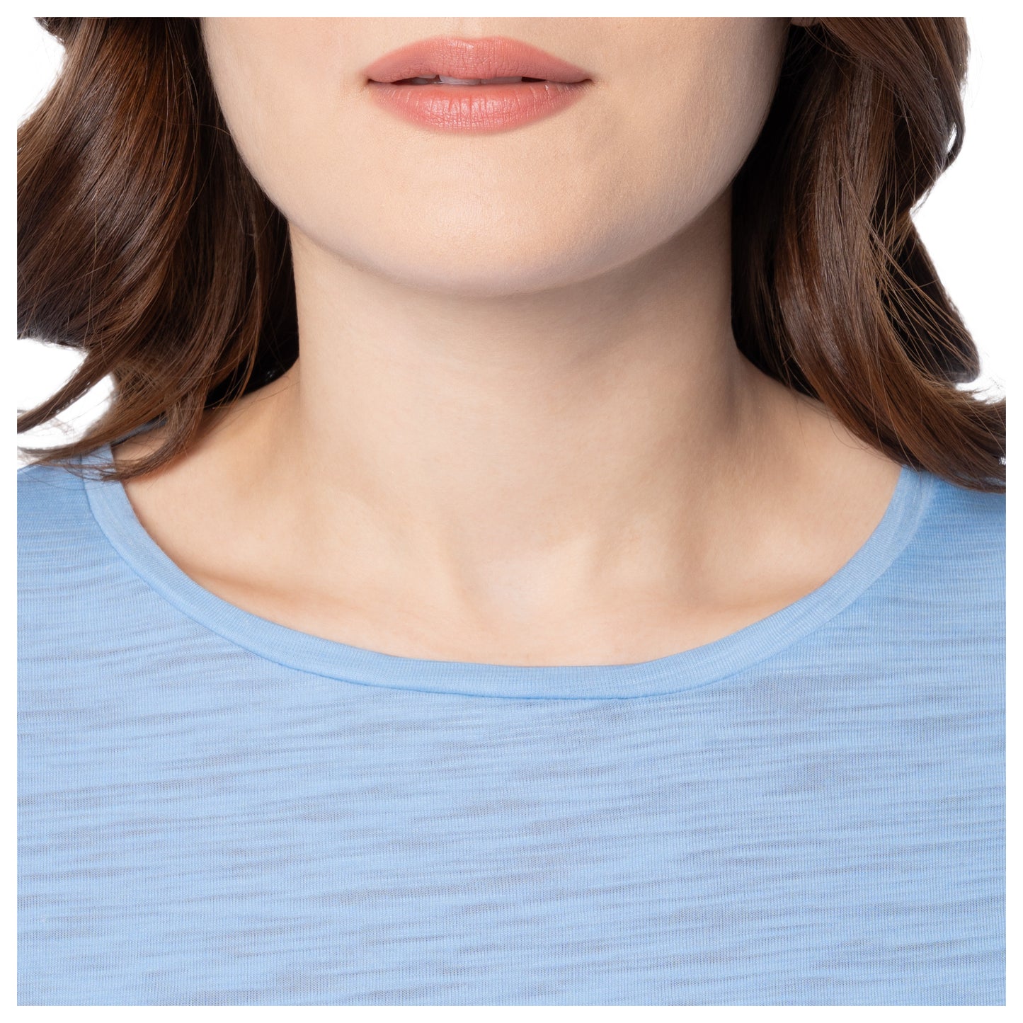 Close-up of a person wearing a light blue shirt with a blurred background