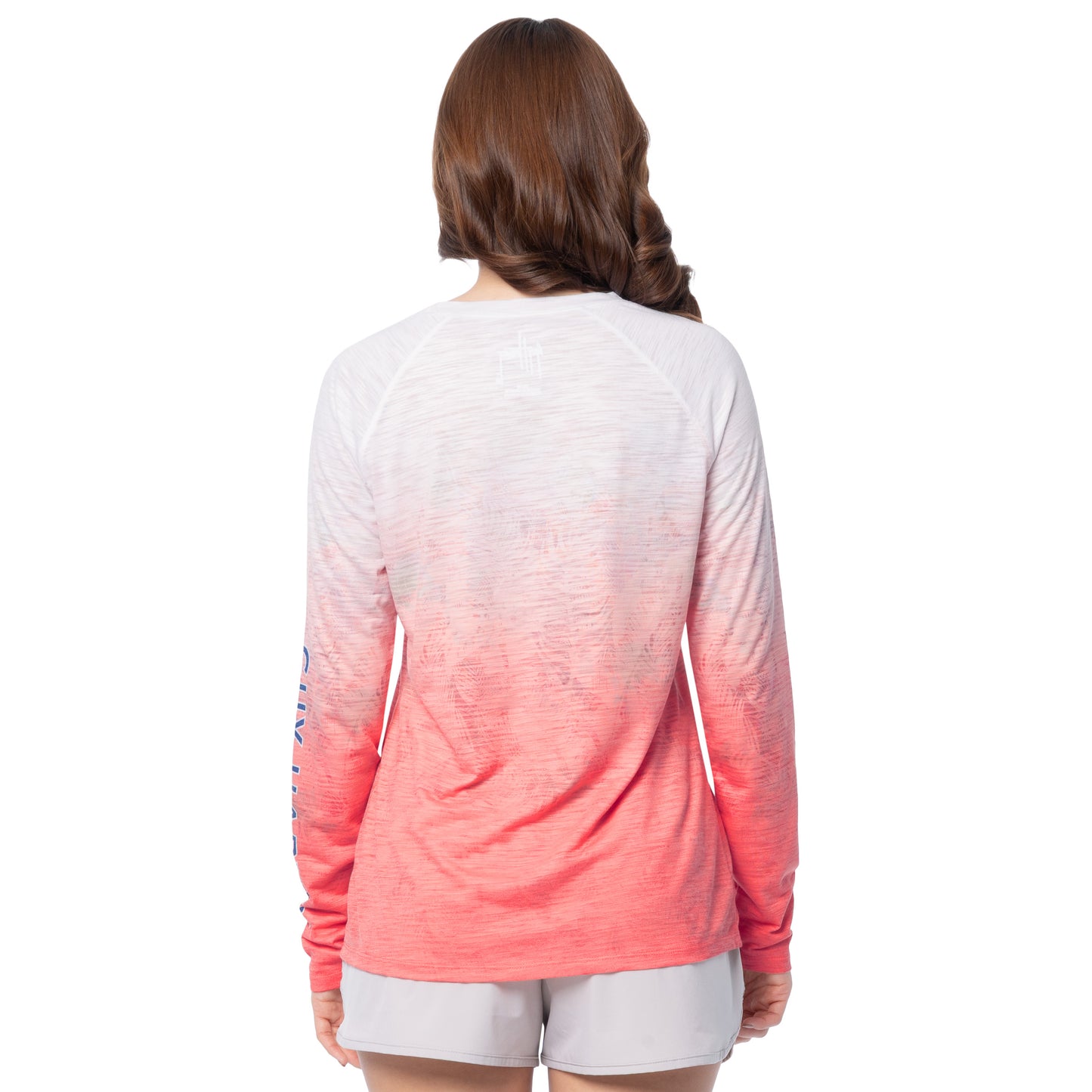 Woman wearing a long-sleeve shirt with a gradient design on a white background