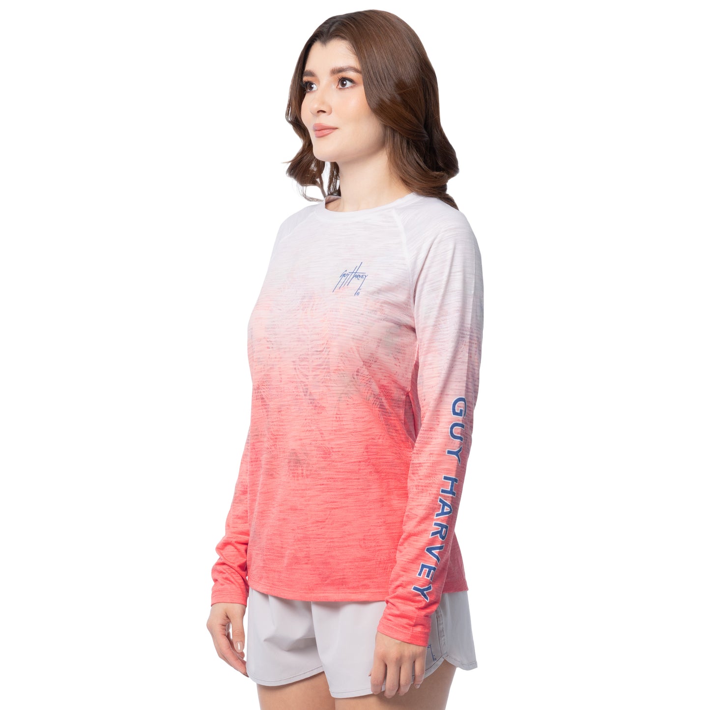 Woman wearing a gradient long-sleeve shirt with visible branding on a white background