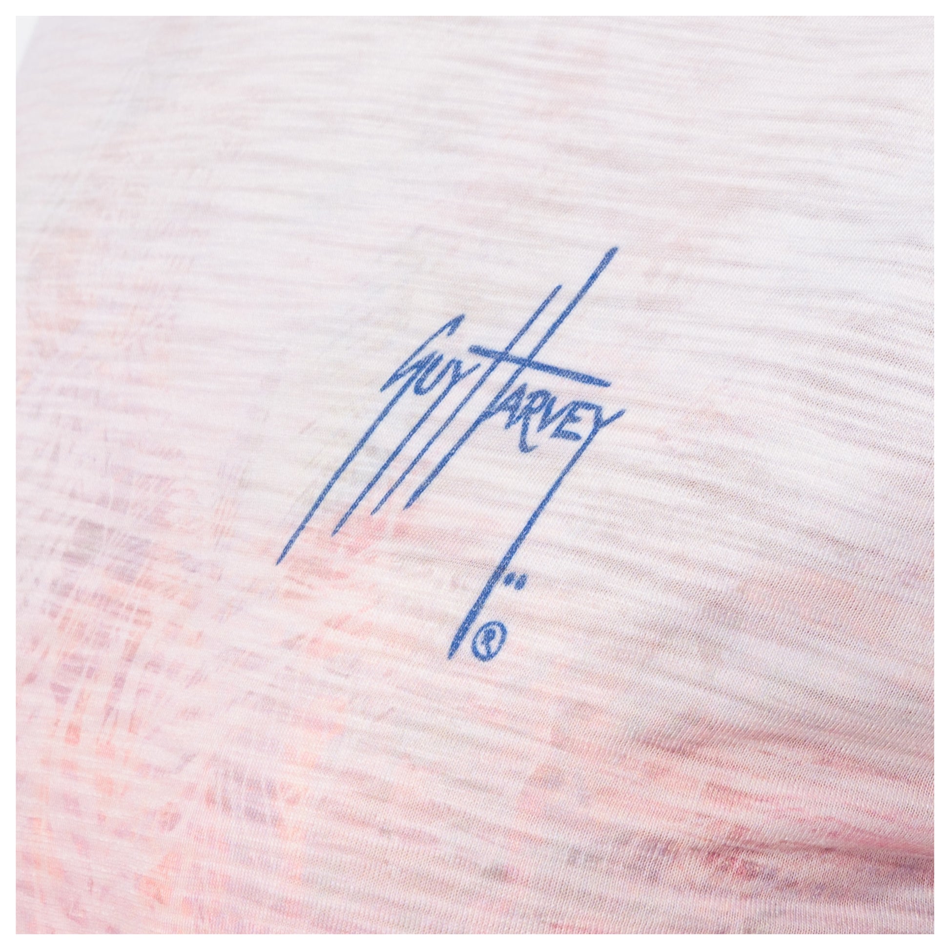 Textured fabric with a blue signature-style Guy Harvey logo on a white background