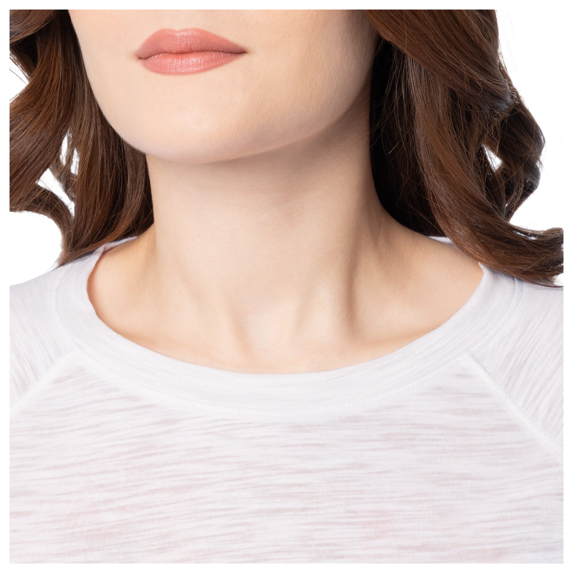 Close-up of a person wearing a white shirt with a blurred background