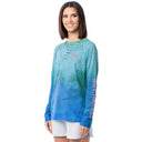 Woman wearing a blue and green gradient long-sleeve shirt with 'Guy Harvey' text on sleeves against a white background