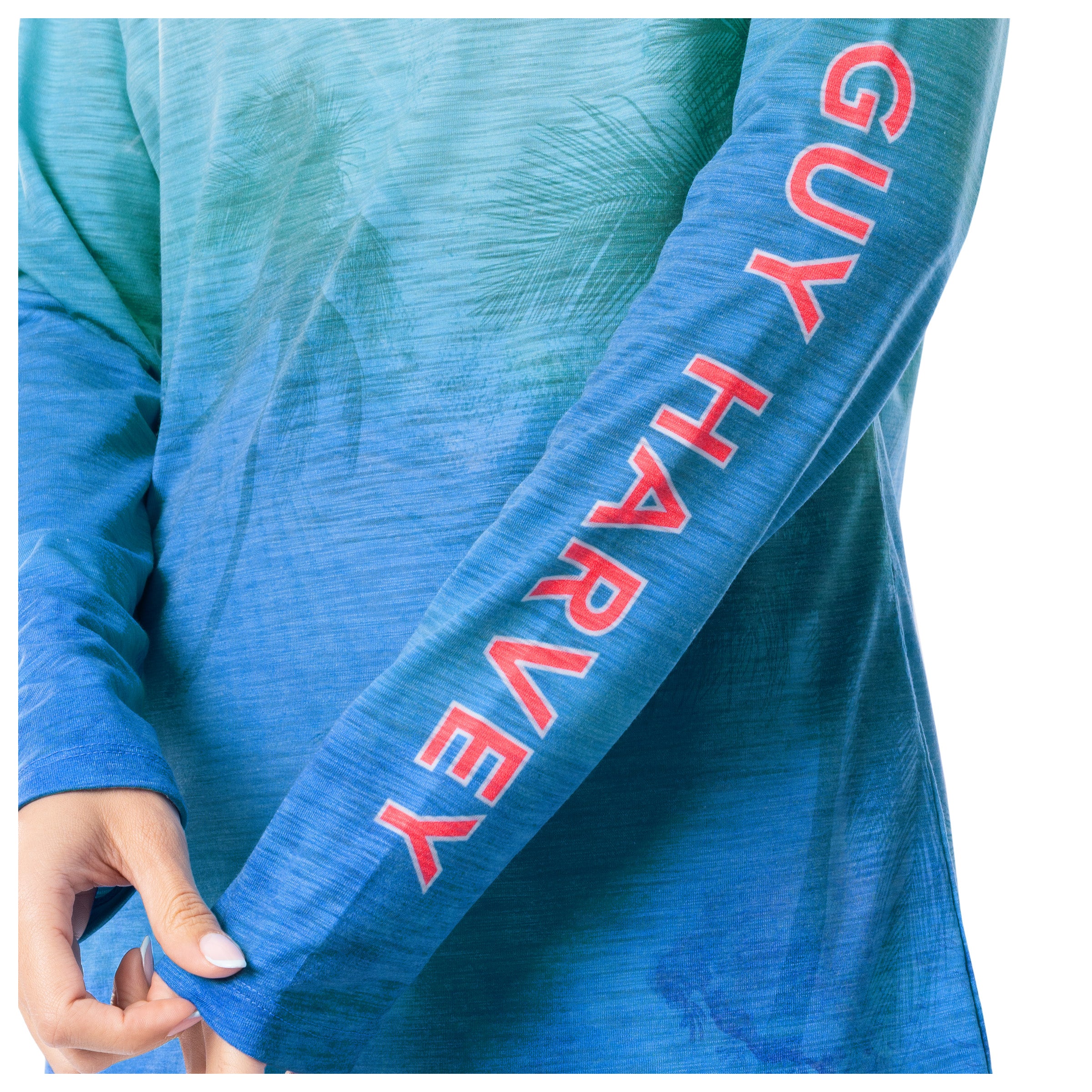 Blue sleeve with 'Guy Harvey' branding on a person wearing a blue shirt.