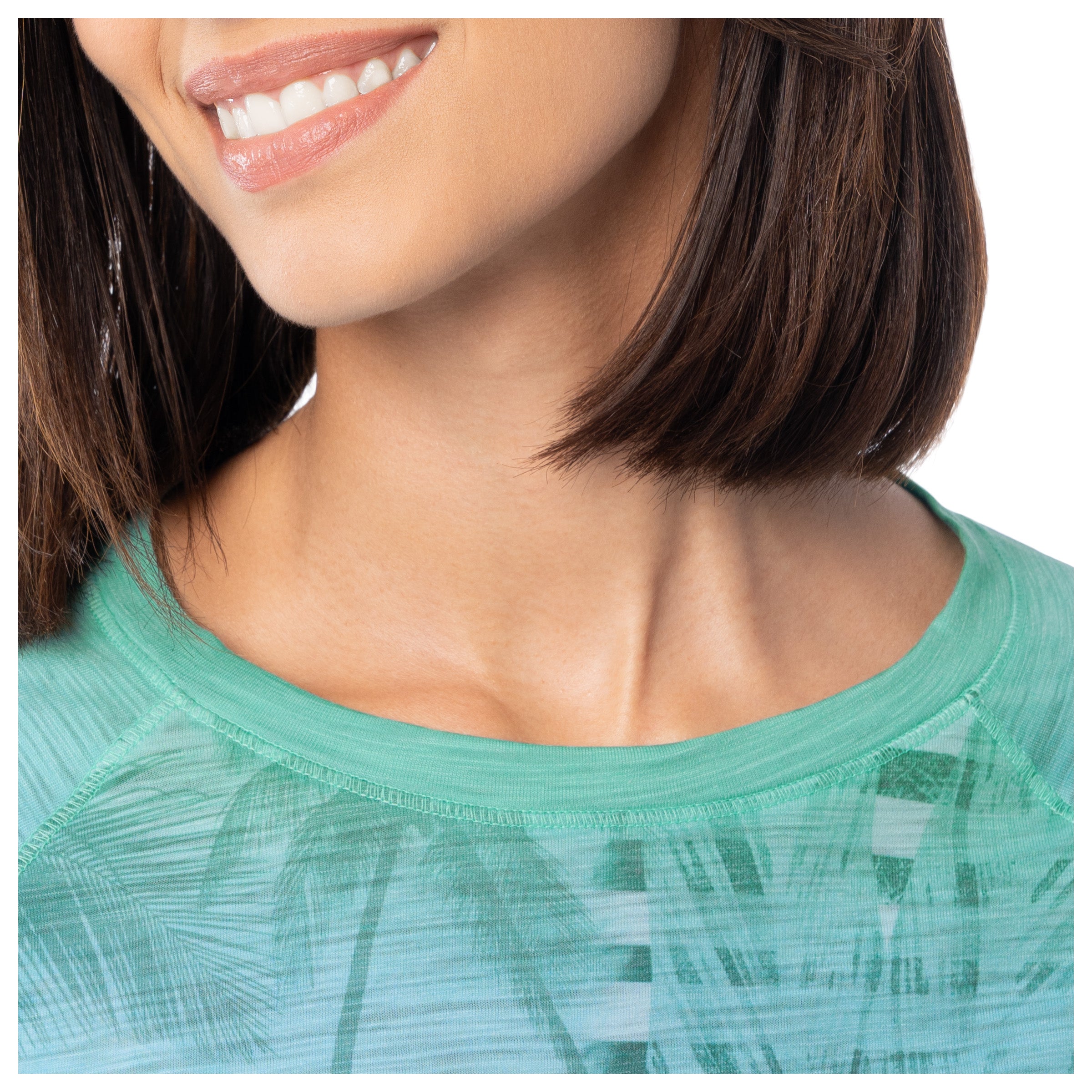 Close-up of a person wearing a green patterned shirt with a blurred background