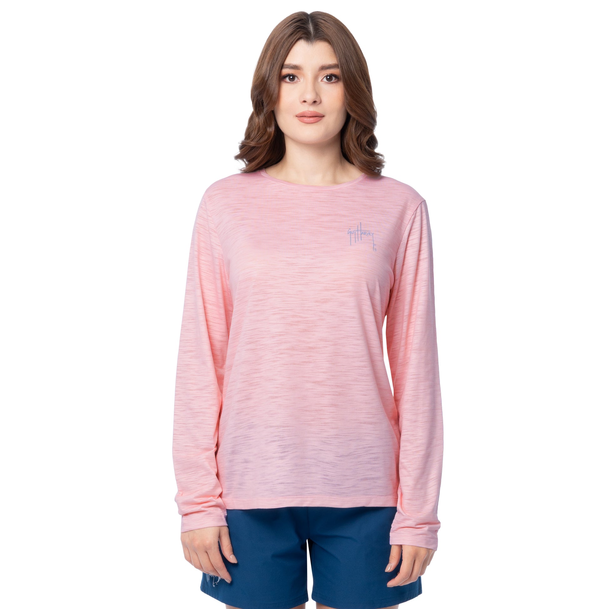 Woman wearing a pink long-sleeve shirt with a small Guy Harvey logo on a white background