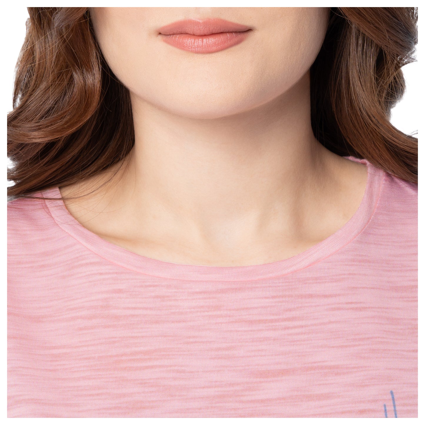 Close-up of a person wearing a pink shirt with a blurred background