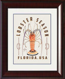 Framed artwork with a lobster illustration and 'Lobster Season Florida, USA' text.