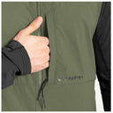 Close-up of a person wearing an olive green zip-front fishing vest with a black long-sleeve layer underneath. A hand is pulling the zipper, and the printed brand name 'GUY HARVEY' is visible on the chest pocket.