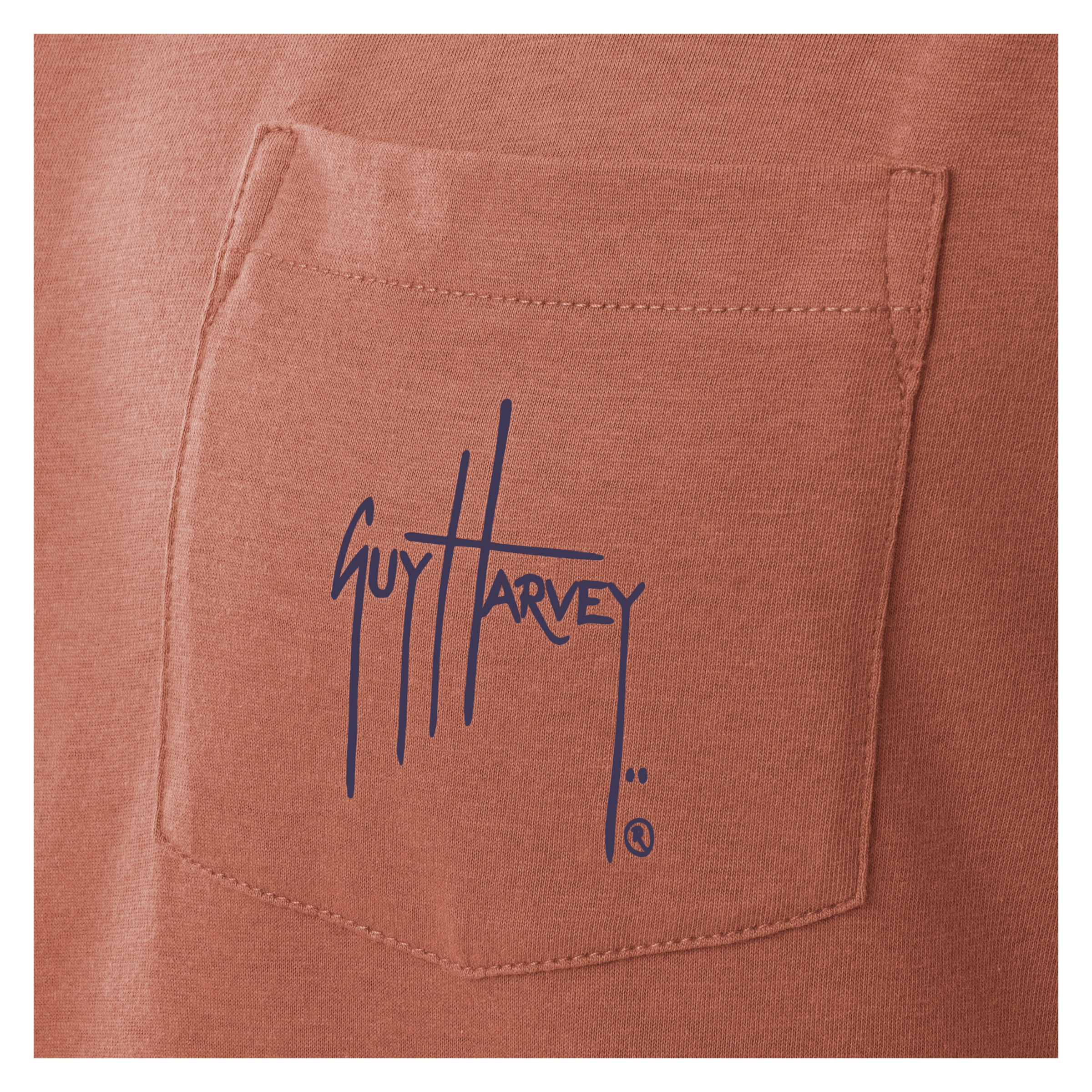 Close-up of a brown fabric pocket with Guy Harvey logo.