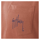 Close-up of a brown fabric pocket with Guy Harvey logo.