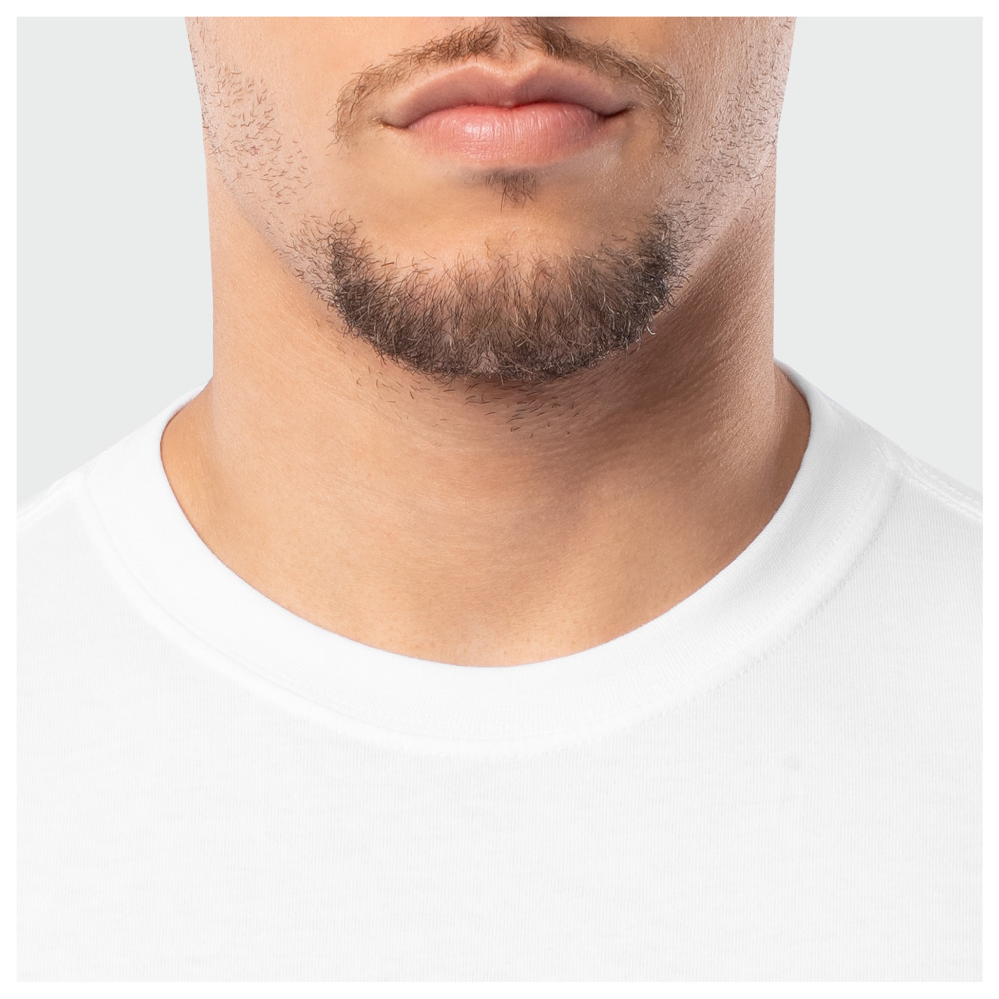 Close-up of a person wearing a white t-shirt with a neutral background
